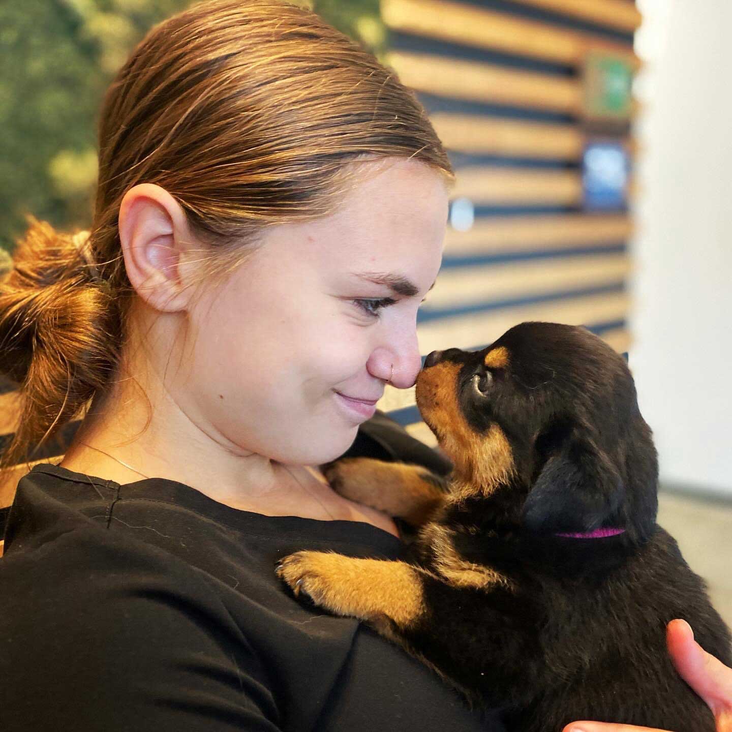 woman at clinic looking at puppy