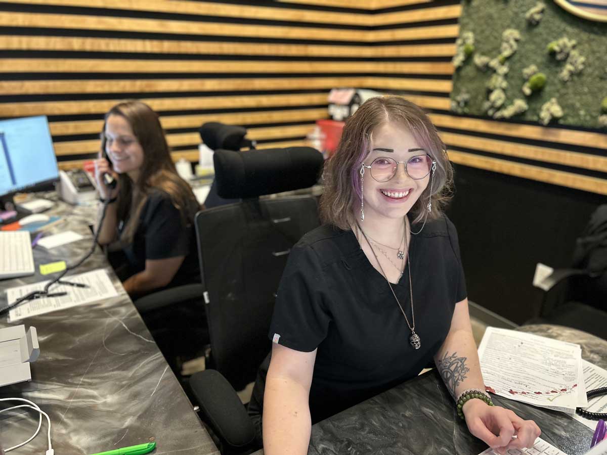 receptionists taking calls at front desk